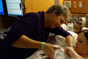 Barbara helps her daughter Kathleen to breasfeed in the hospital.